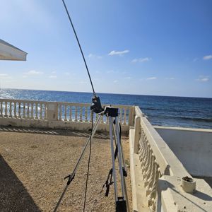 A radio setup on the shore with the ocean in the background and a clear blue sky.