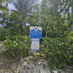 Sign for Heritage Beach with surrounding lush greenery.