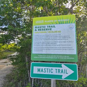 Signage indicating the Mastic Trail and Reserve Southern Trailhead, surrounded by greenery.