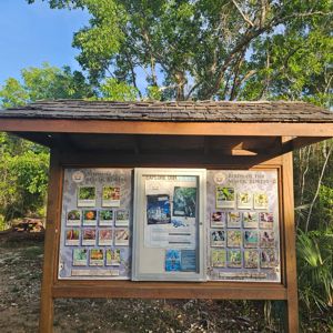 Information board at a park site displaying wildlife and birds of the Mastic Forest.